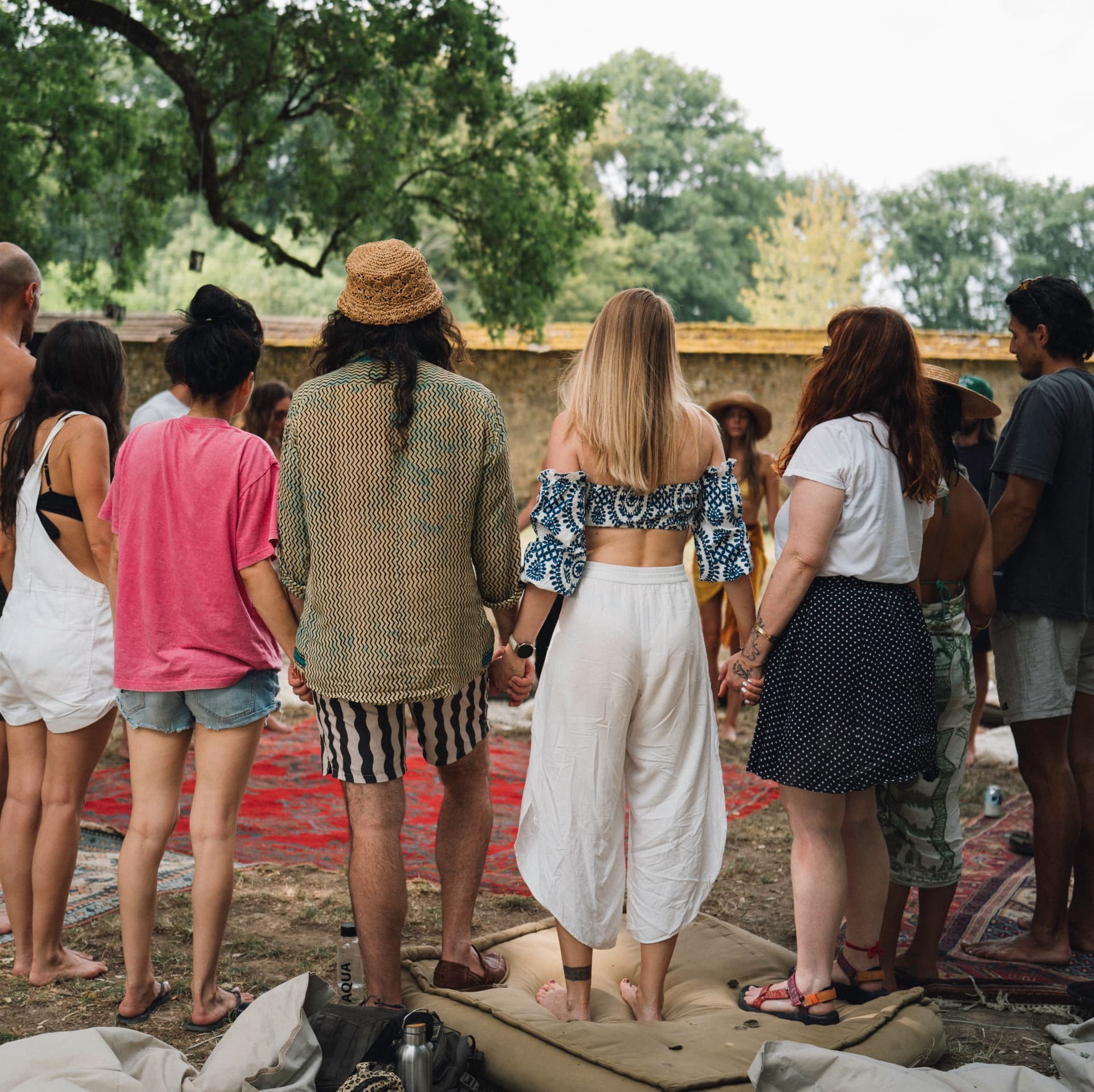 Participants standing hand in hand in an outdoor constellation circle